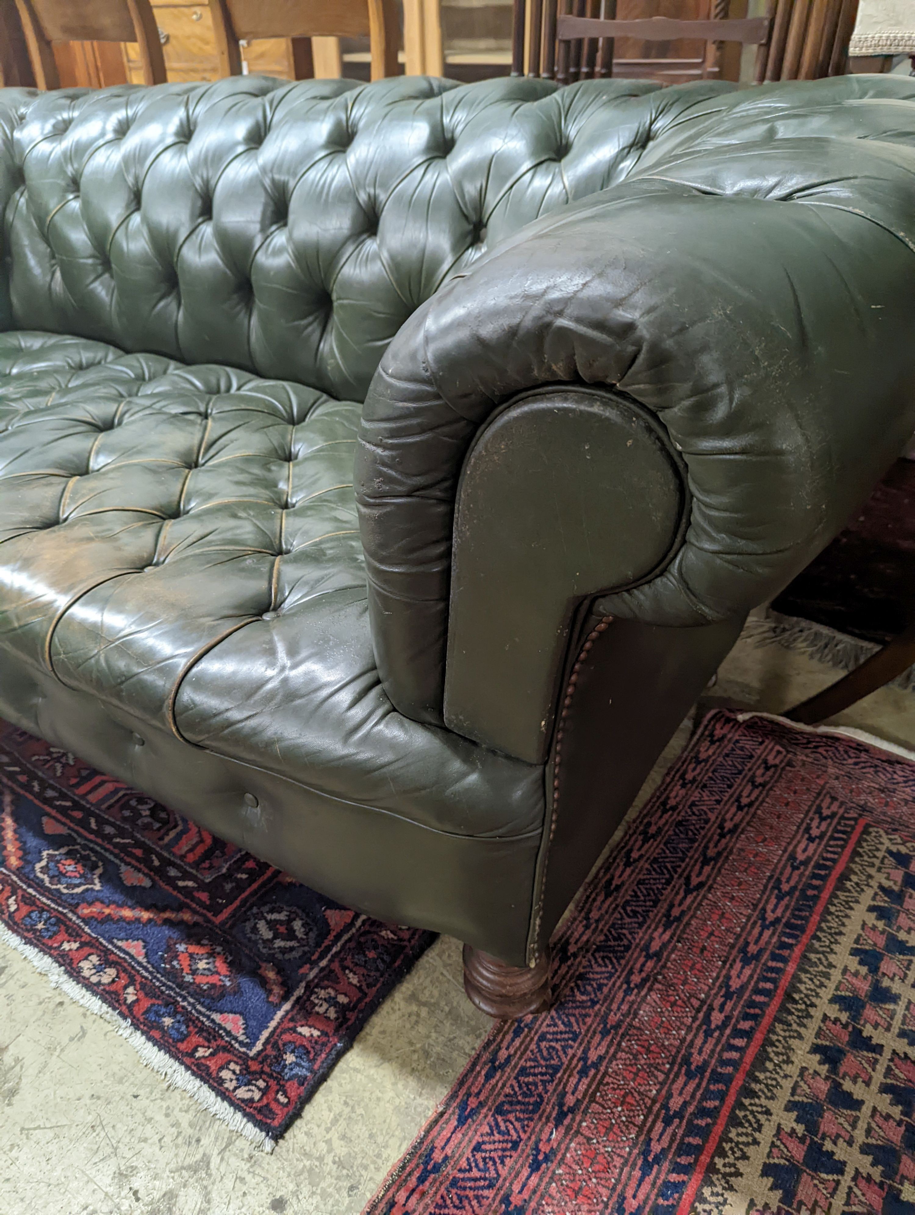 A late Victorian buttoned green leather Chesterfield settee, length 184cm, depth 82cm, height 70cm